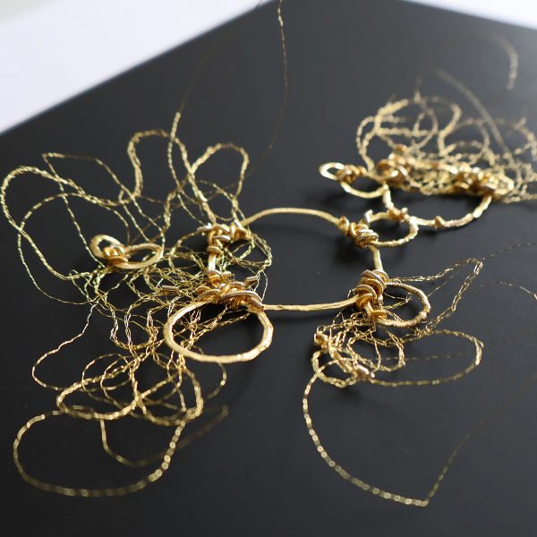 Broderie d'or sur papier noir